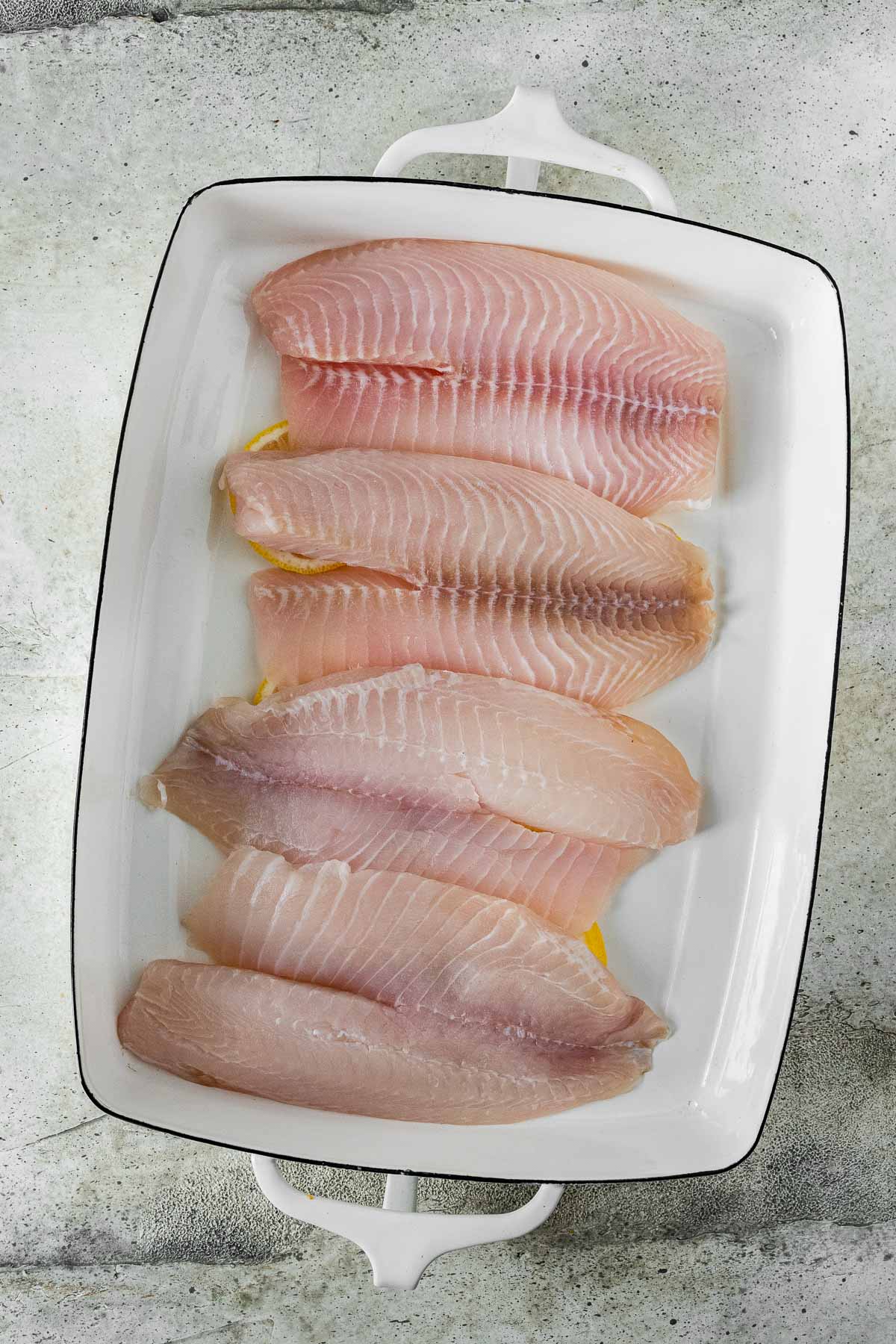 tilapia fillets in a baking dish