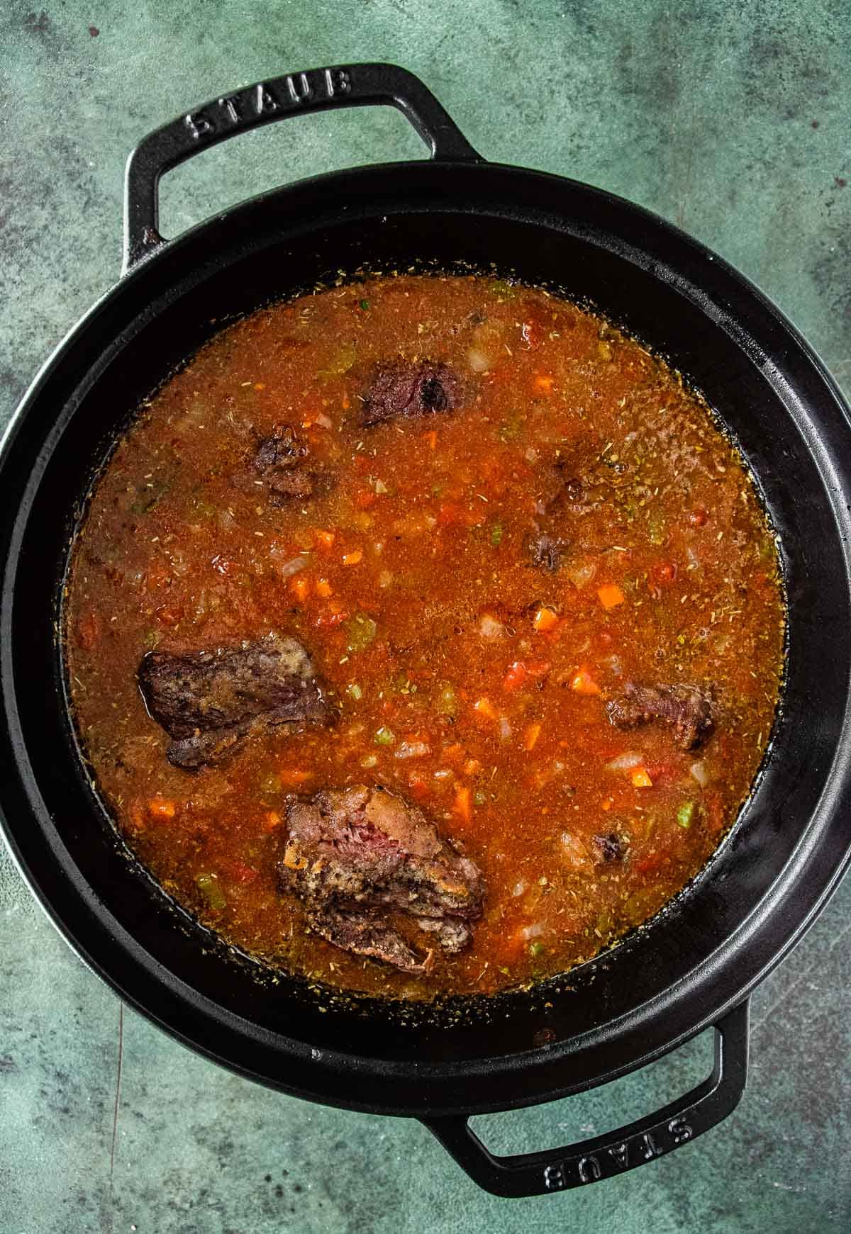 meat simmering in pot 