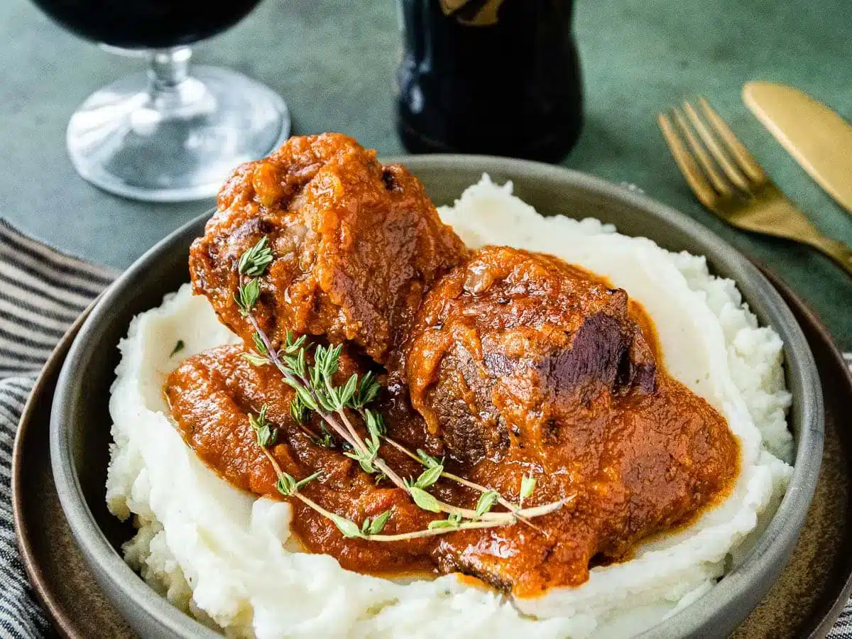 plated short ribs on top of mashed potatoes 