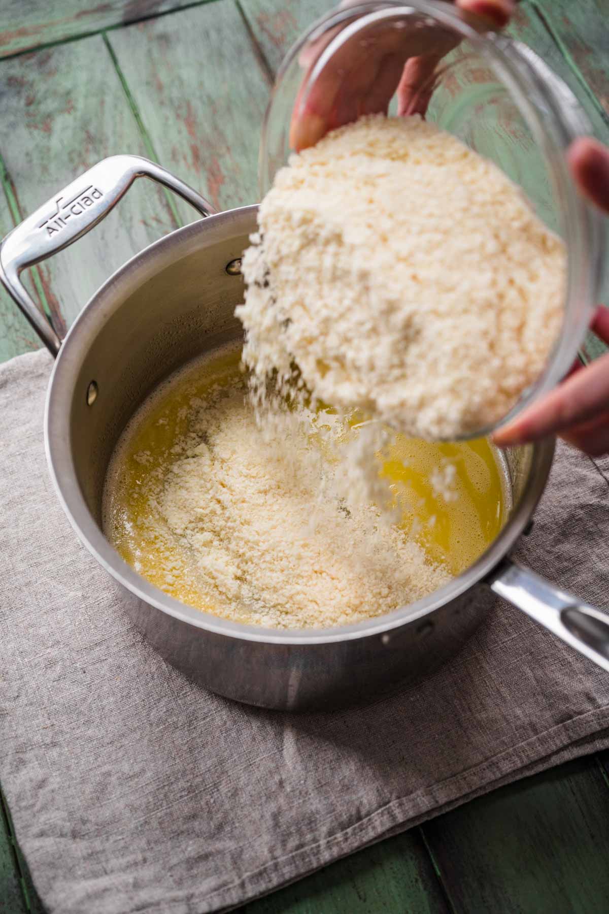 adding potato flakes to melted margarine