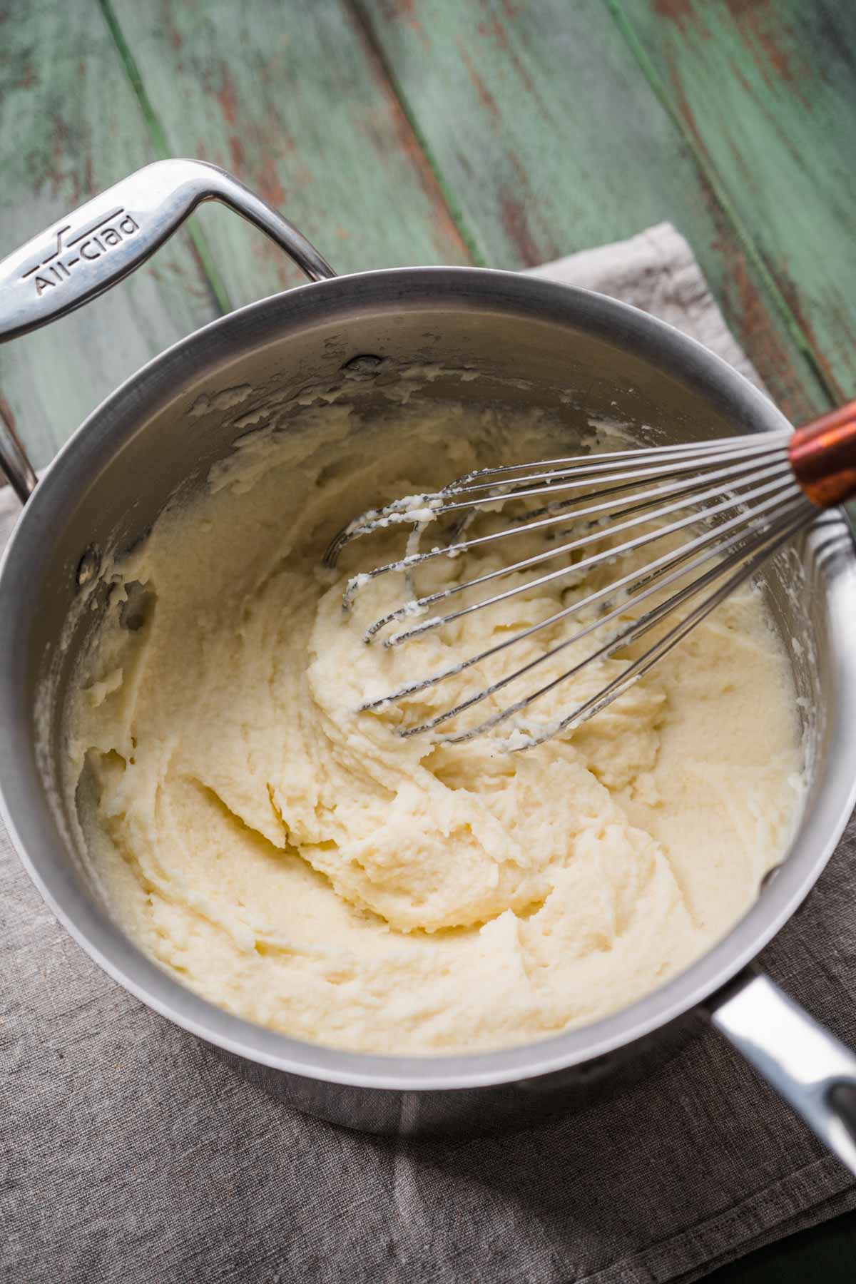 whisking the pot to make creamy potatoes