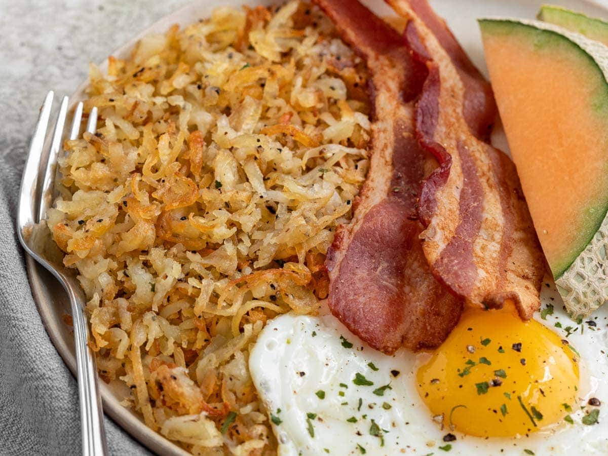 plated hash with bacon and egg