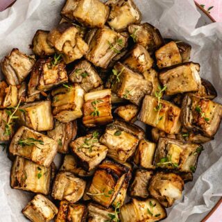 eggplant in bowl lined with parchment paper.