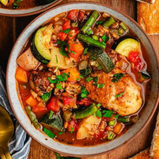 Bowl of soup with chicken and vegetables.