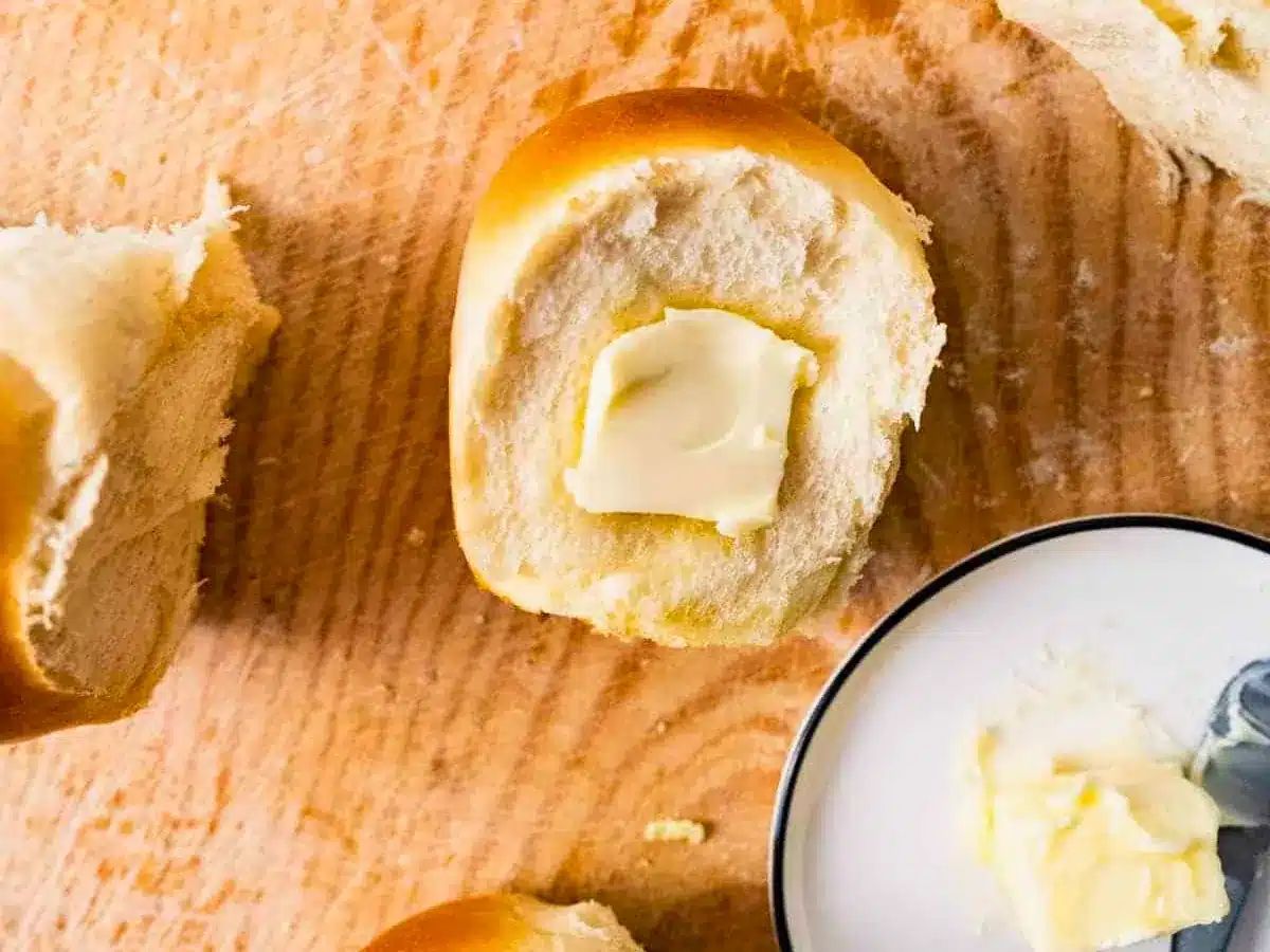 Single bread roll with pat of butter