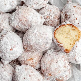 Powdered sugar coated donuts.