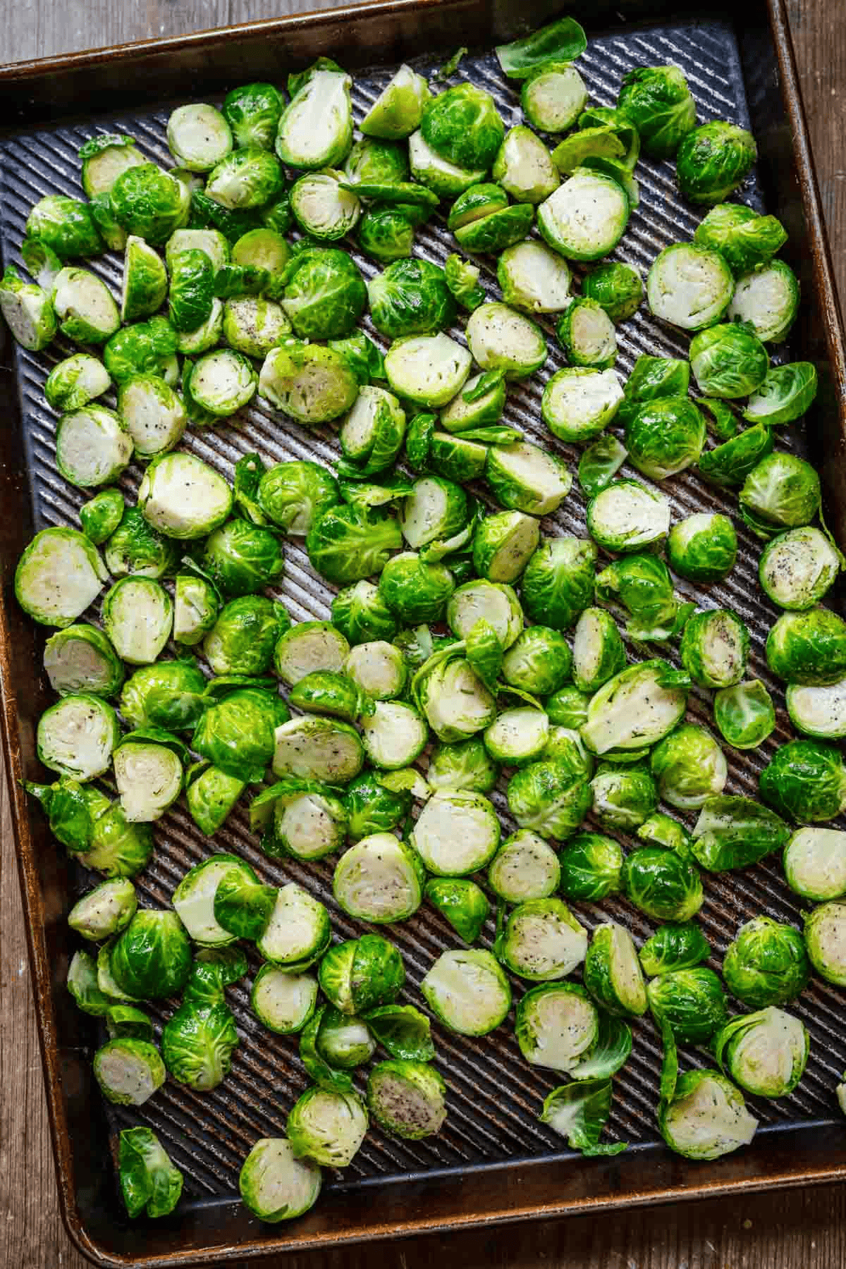 Halved Brussels sprouts on a baking sheet