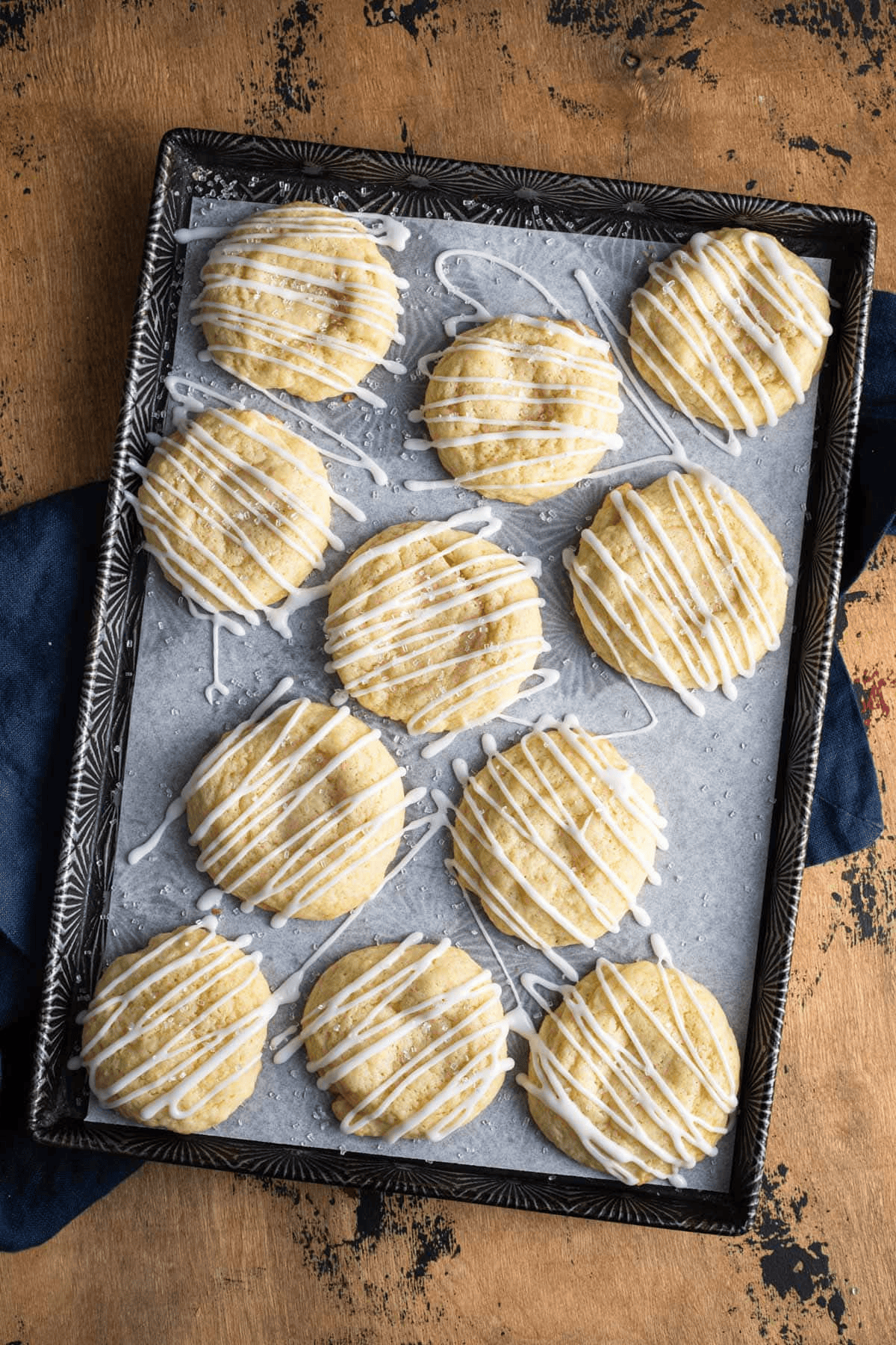 Cookies on a baking sheet with glaze zig zagged over top