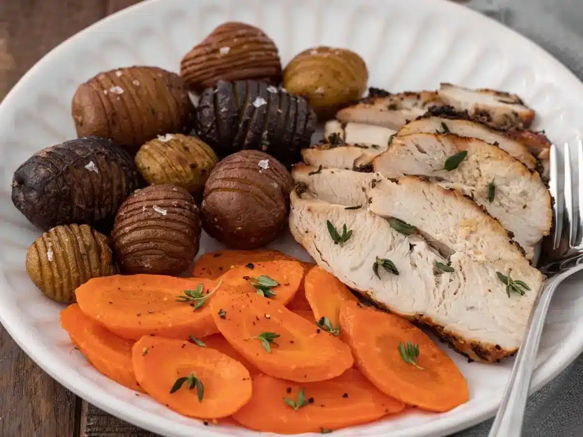 slices of turkey breast with carrots and potatoes