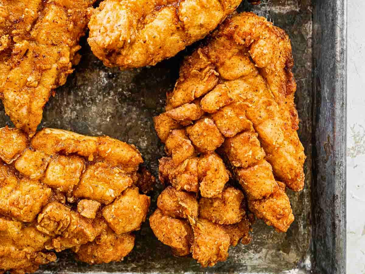 Crispy fried chicken on a baking sheet