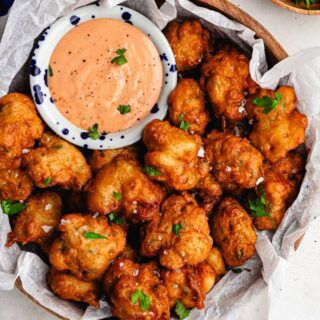 Serving platter with fried seafood fritters.