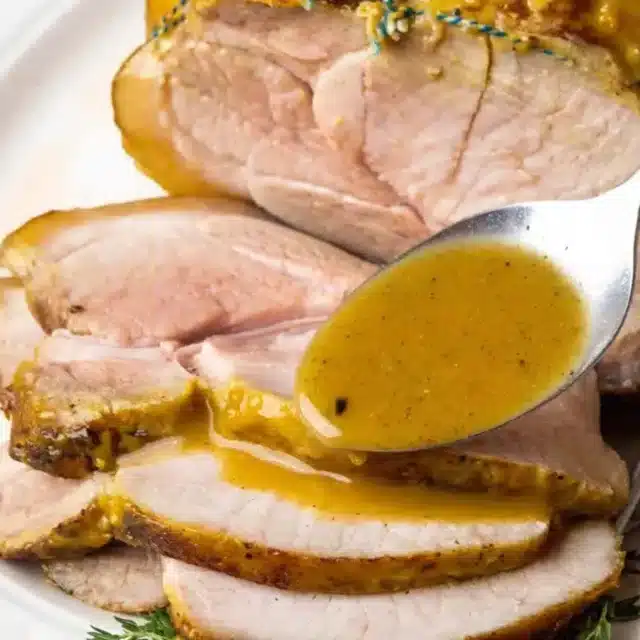 adding sauce over sliced pork