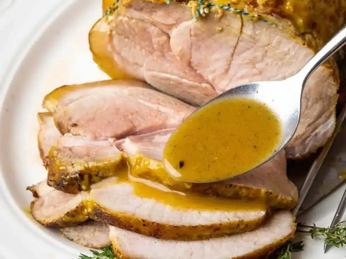 adding sauce over sliced pork