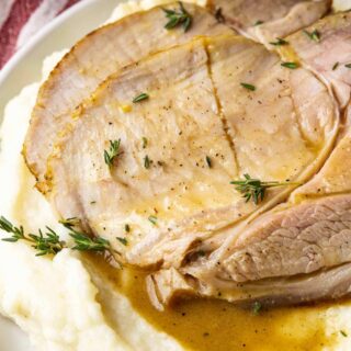 Maple Brined Pork Loin plated slice over mashed potatoes with gravy, ratio 1x1