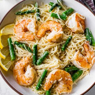 Pasta and shrimp dish in shallow dinner bowl.