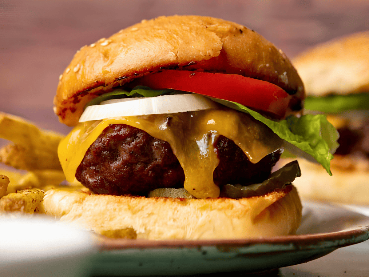 Burger with cheese, vegetables, and a bug