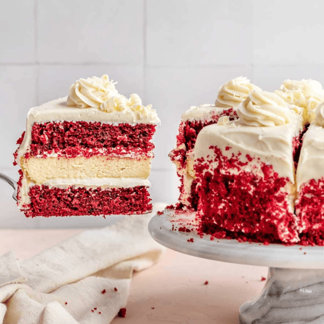 slice of cake being taken from whole cake
