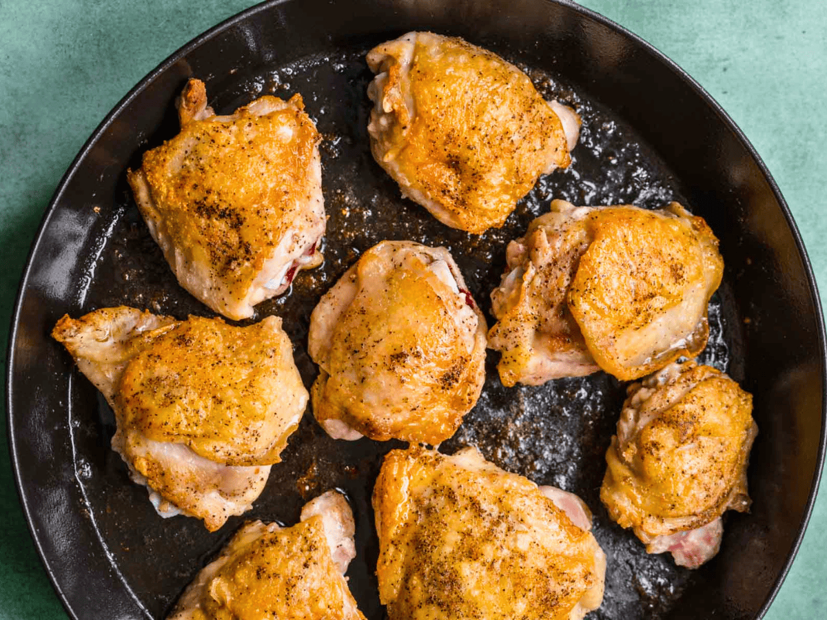 chicken being seared on a pan