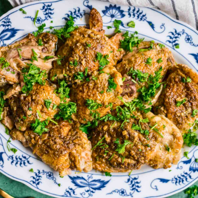 Crispy chicken on a plate with green garnish
