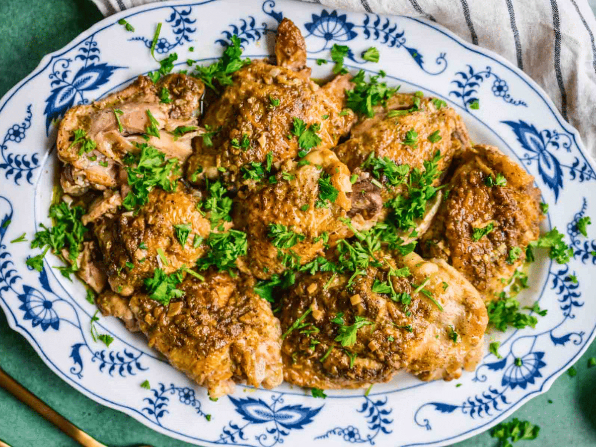 Crispy chicken on a plate with green garnish