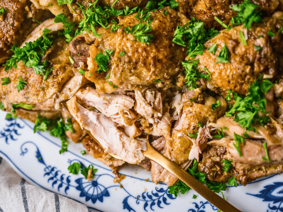 crispy chicken with green garnish with a fork in it