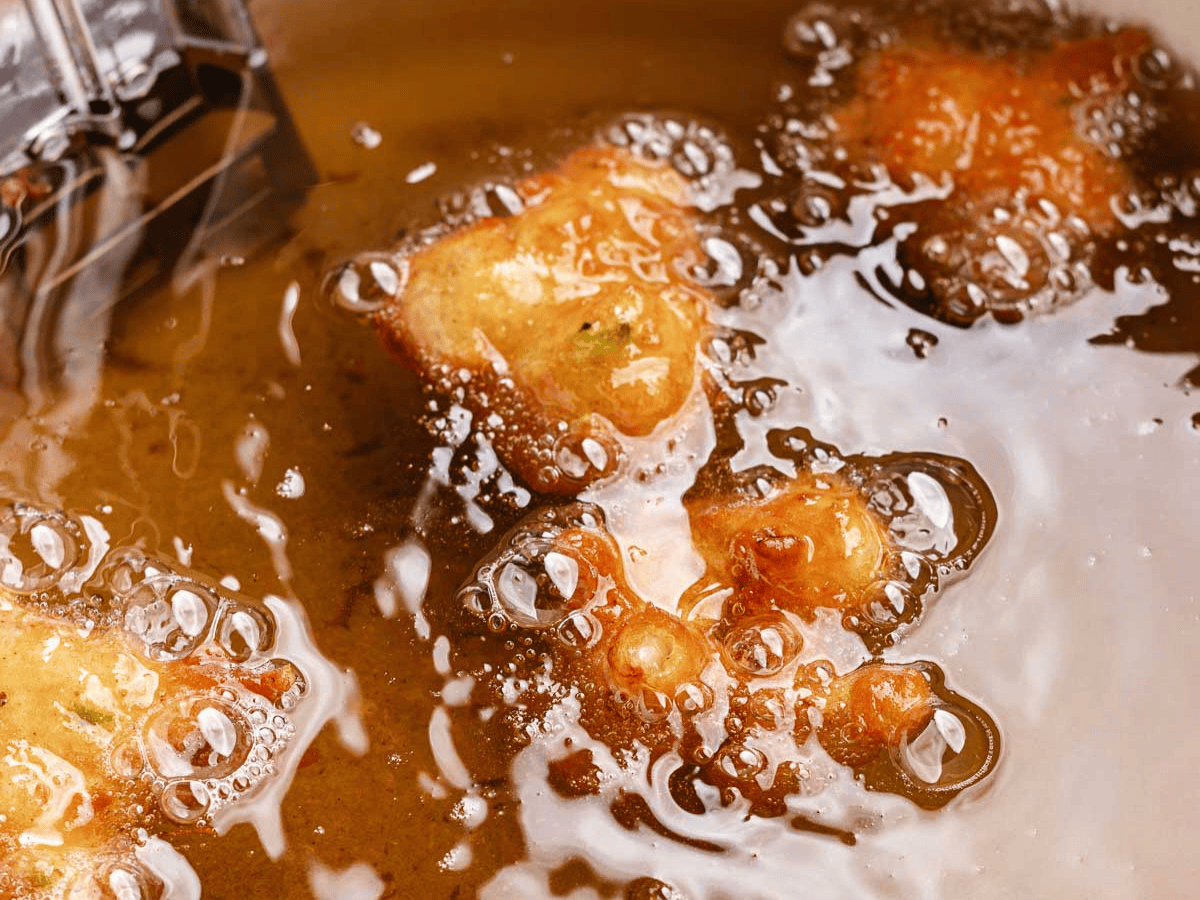 Seafood fritters frying in oil.