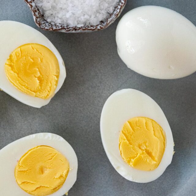Hard boiled eggs cut in half on plate.