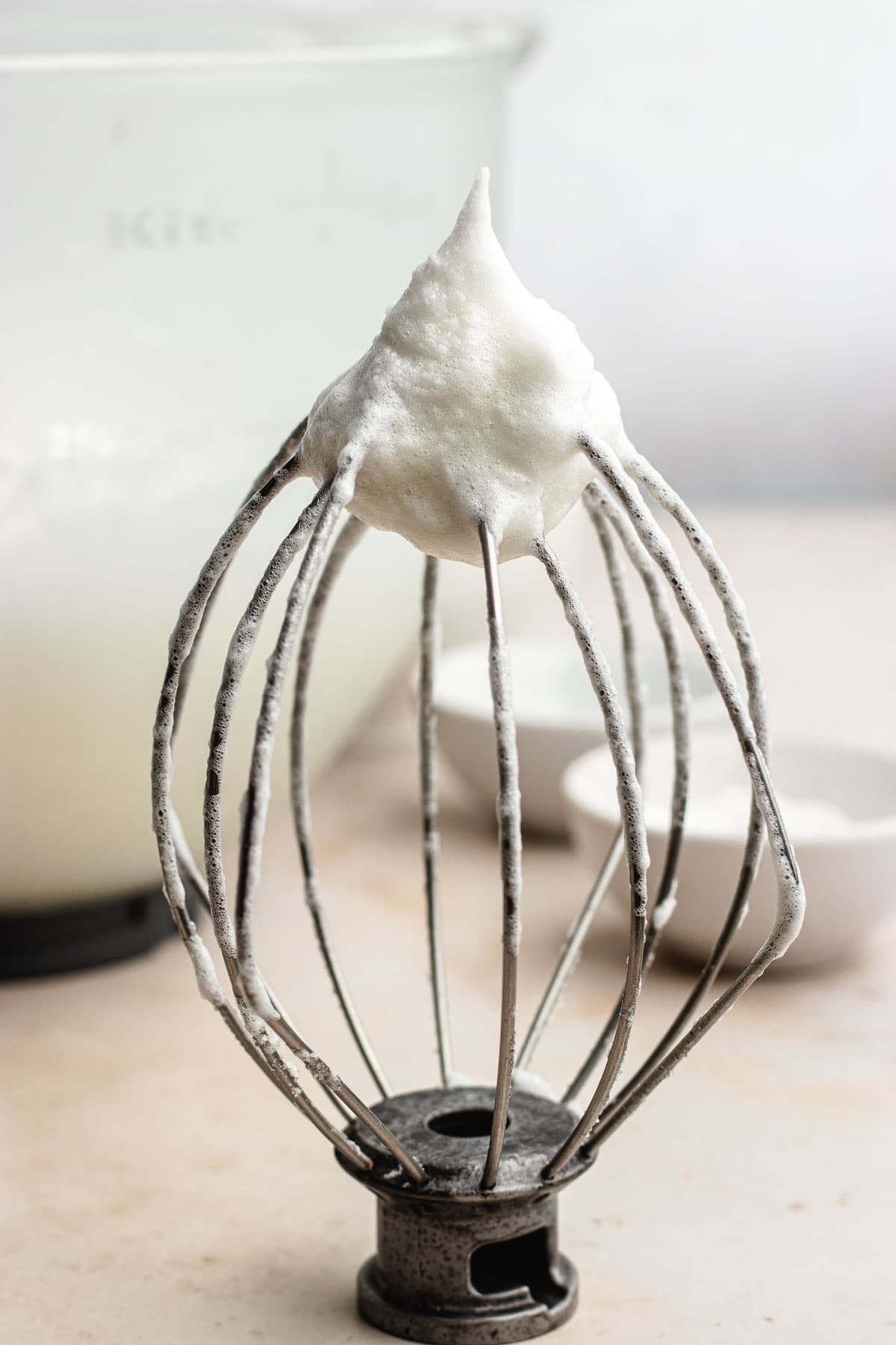 Lady Baltimore Cake whisk sitting with tip upright with whipped egg whites on tip