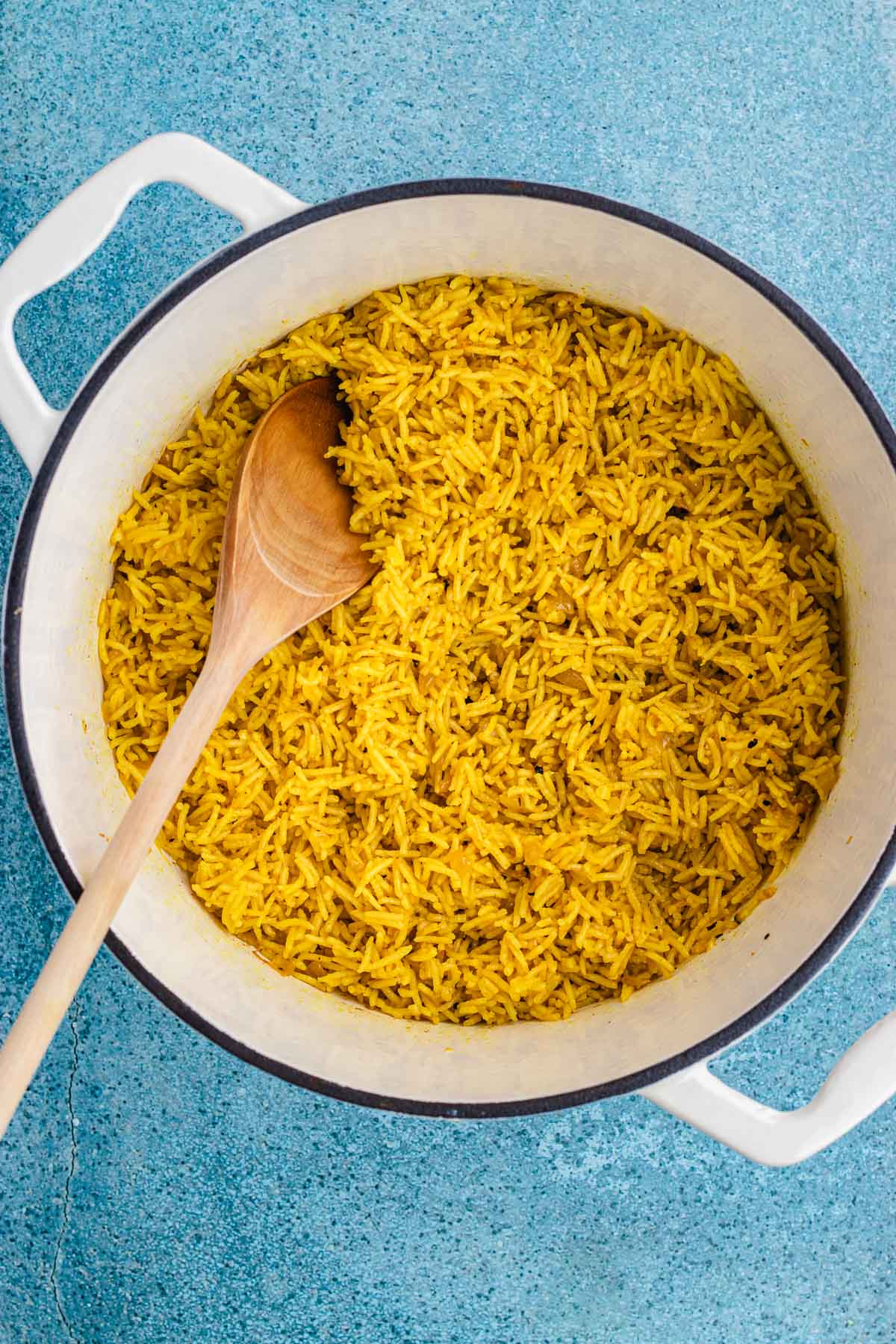 bowl of rice with wooden spoon 