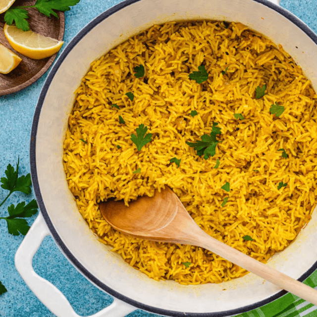 pot with rice in it with wooden spoon