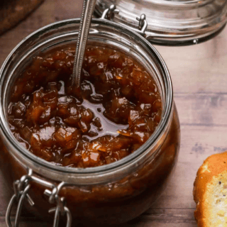 glass jar full of jam with spoon