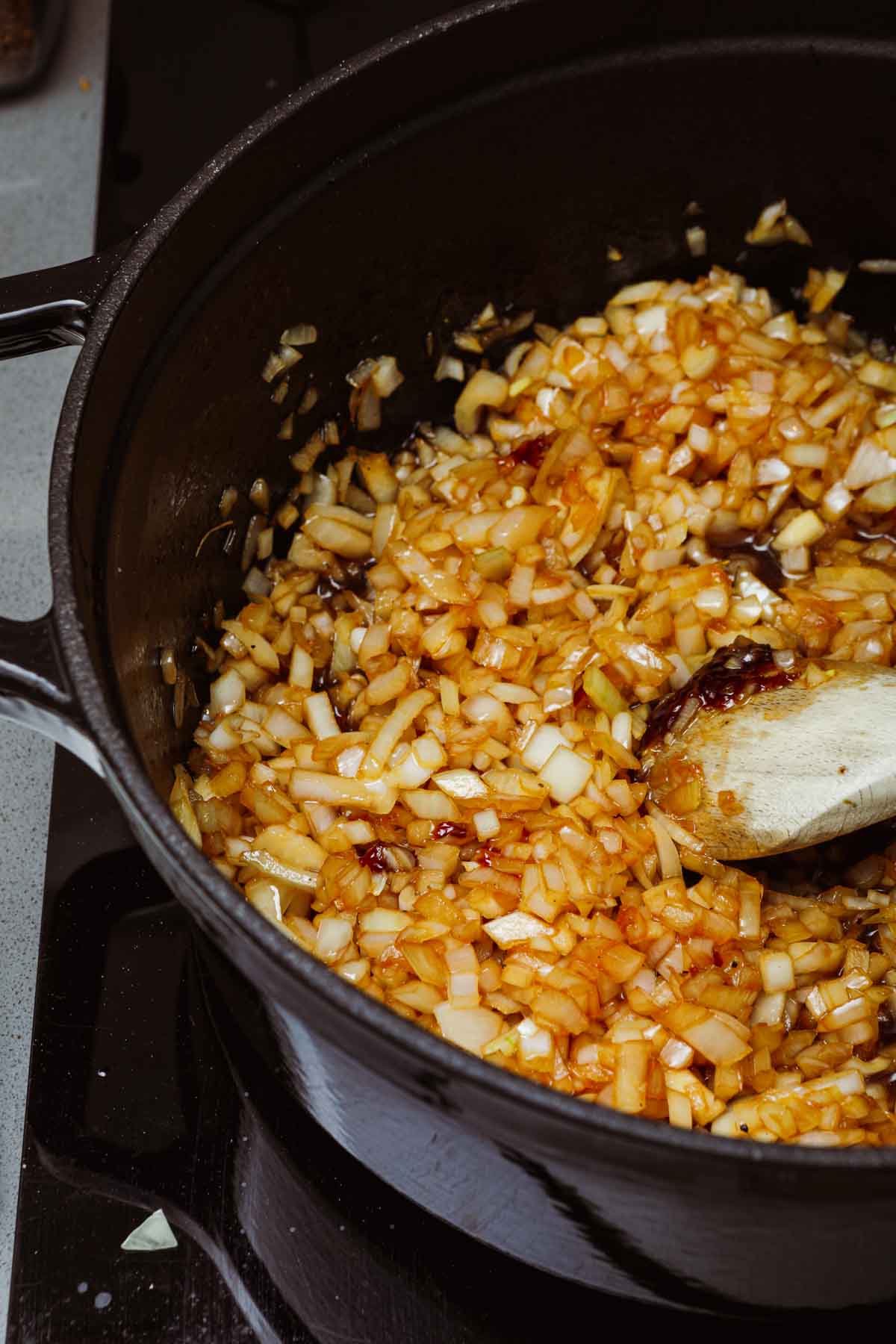 onions being mixed in pot 