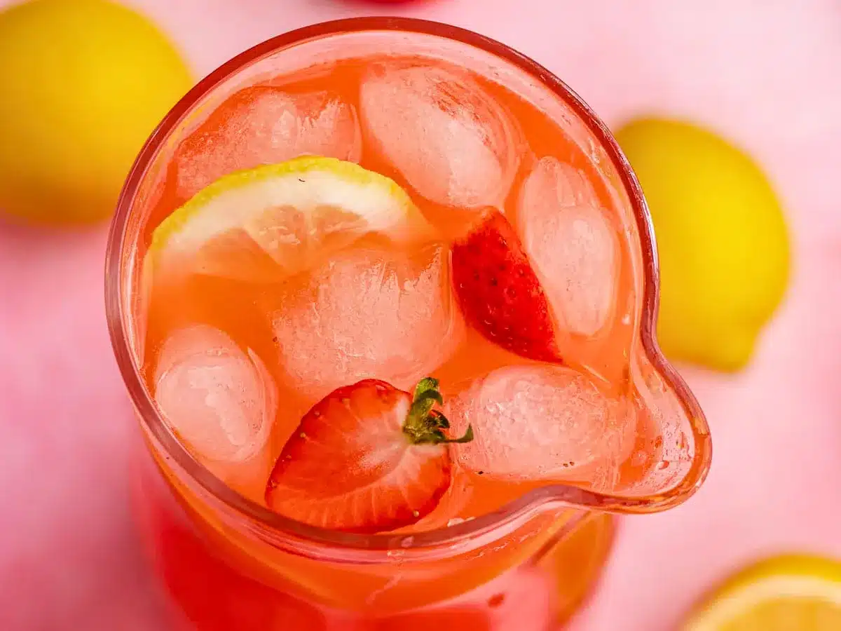 Pitcher of drink with strawberries and lemons