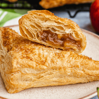 two apple-filled flaky dough on a plate