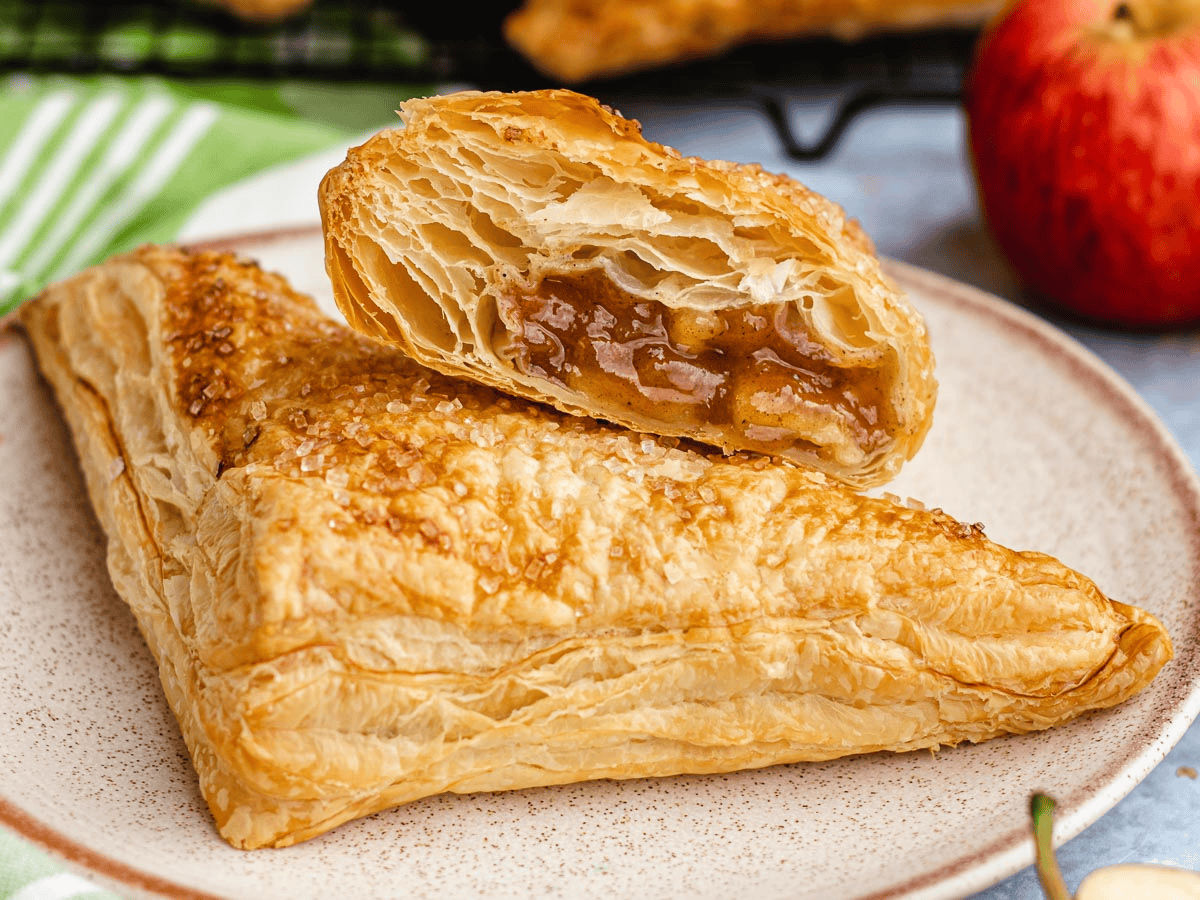 two apple-filled flaky dough on a plate