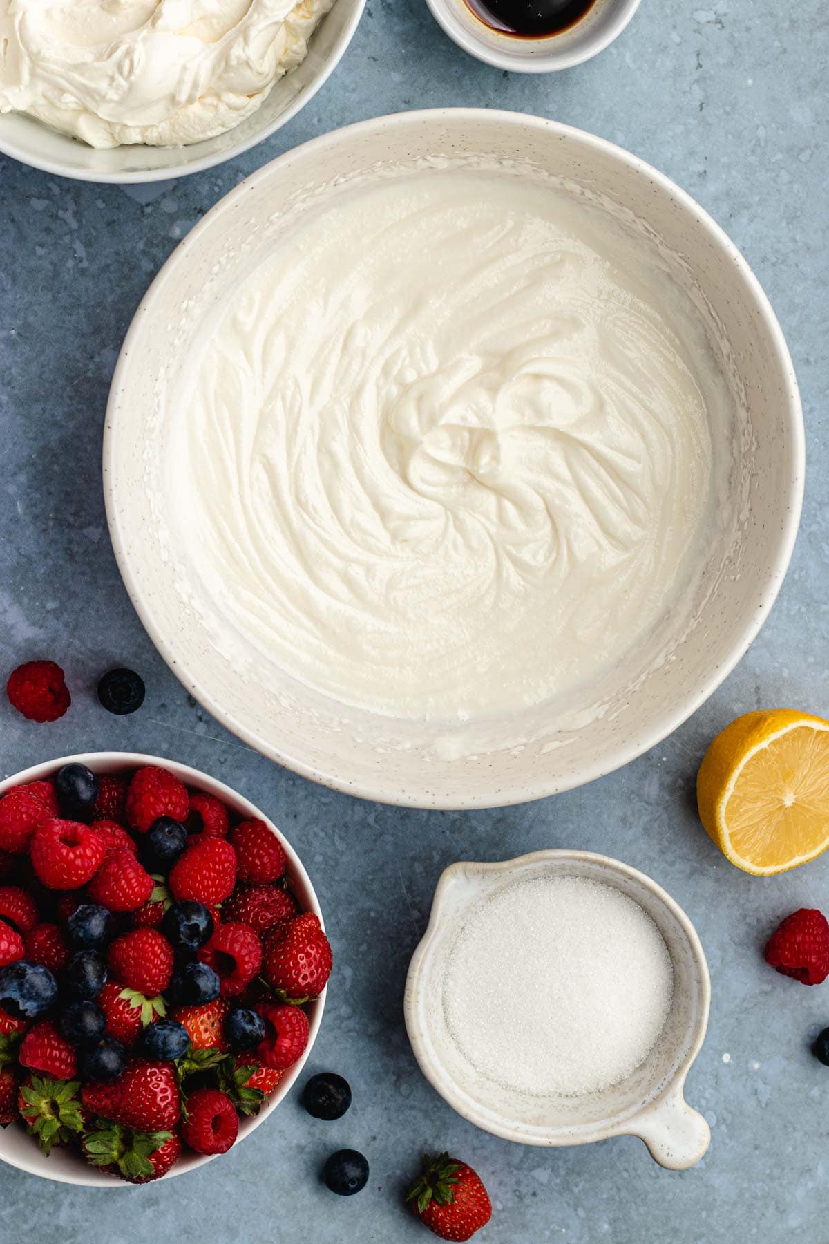 Cheesecake Parfaits whipped cream cheese in bowl and ingredient layers in separate bowls.