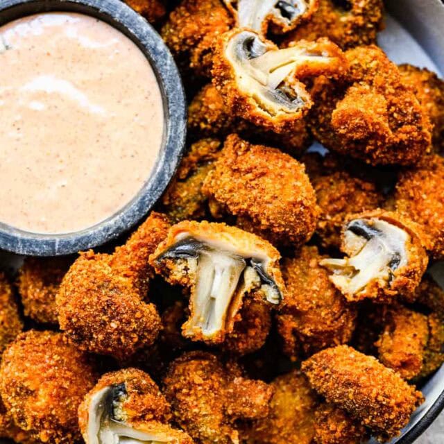 Serving plate of fried appetizer with dipping sauce.