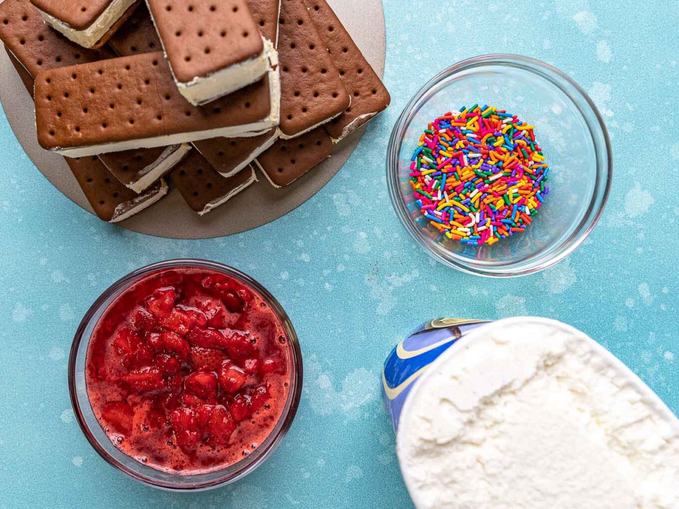 Ice Cream Sandwich Cake ingredients spread out on blue counter top