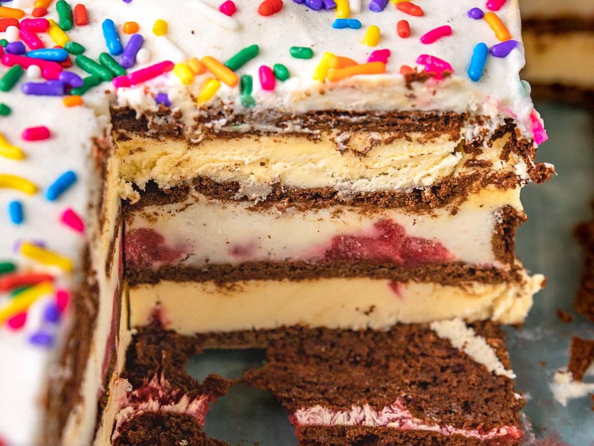 Ice Cream Sandwich Cake close up view of cake in dish with slice removed to see inner cross section of cake.