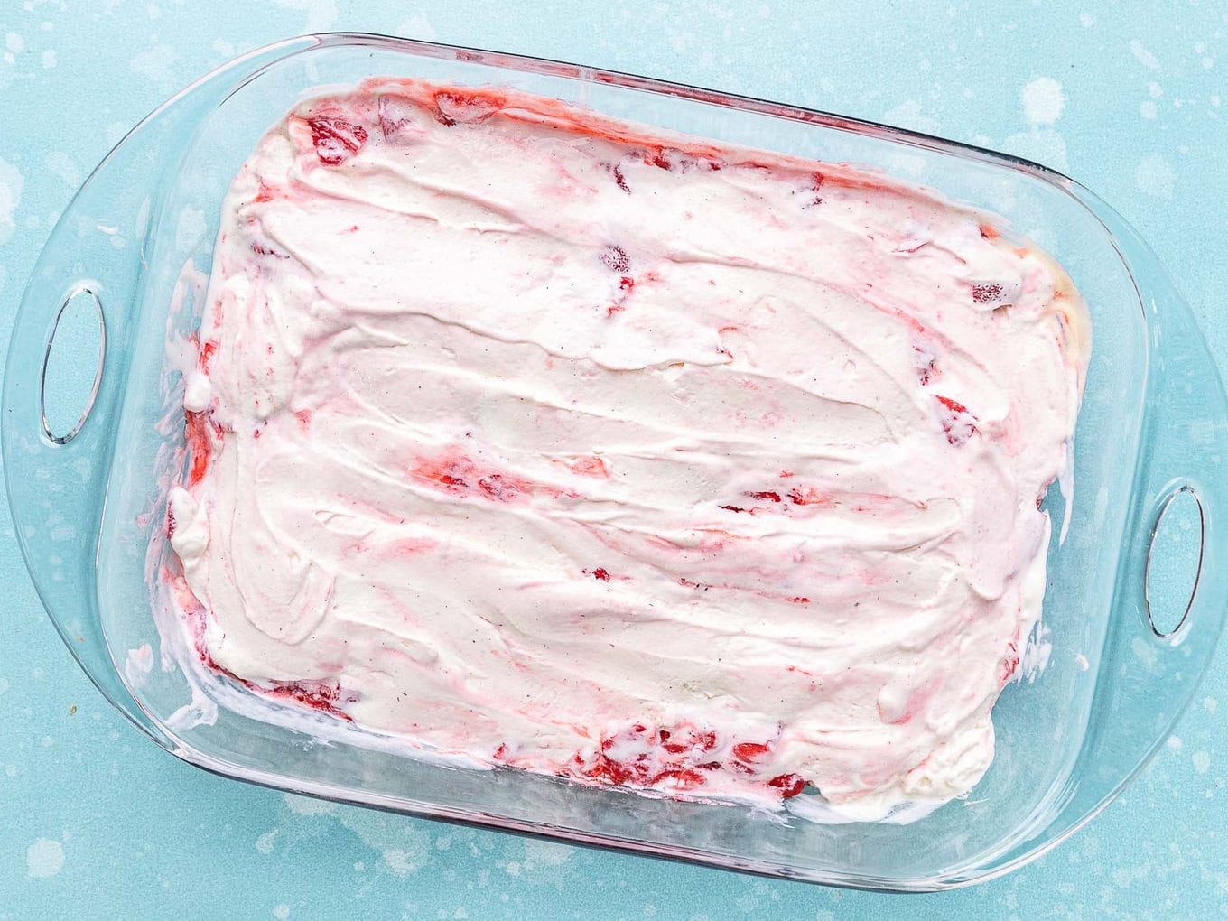 Ice Cream Sandwich Cake vanilla ice cream spread over the berry topping layer.