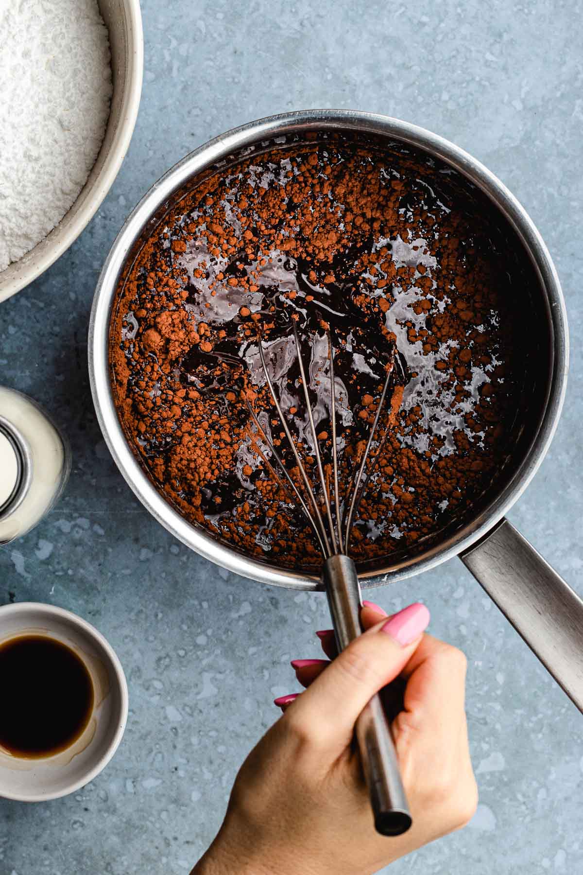 adding ingredients to make frosting