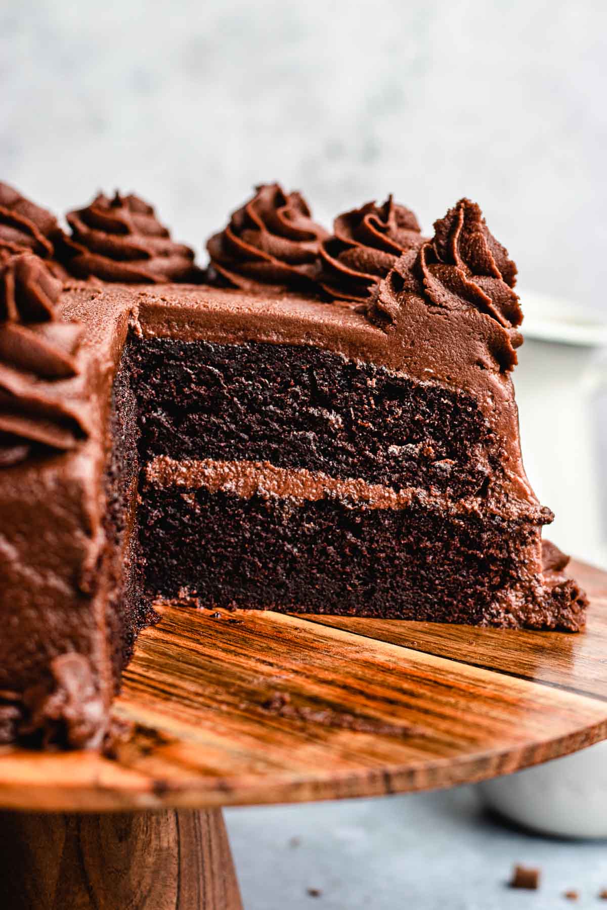 cake with a slice taken on a wooden cake tray 