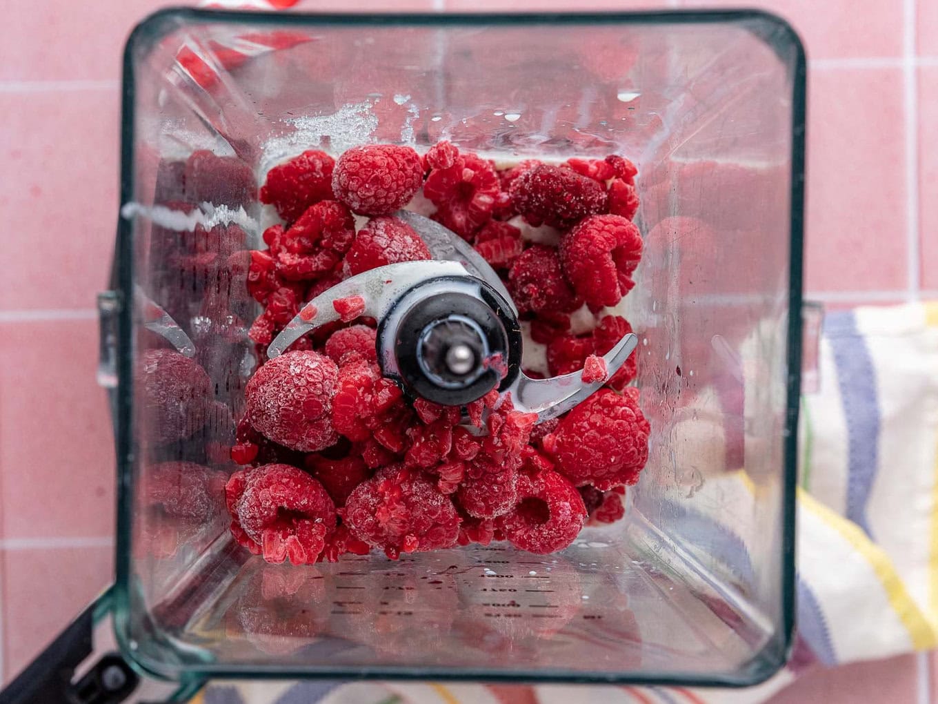 Raspberry Sherbet frozen berries in blender. Top down view.