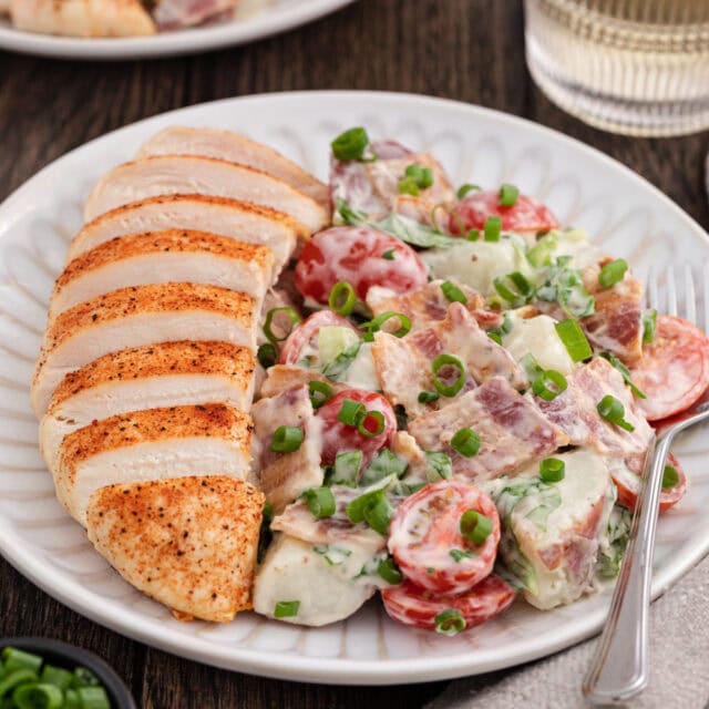 plate with sliced chicken breast and BLT Potato Salad