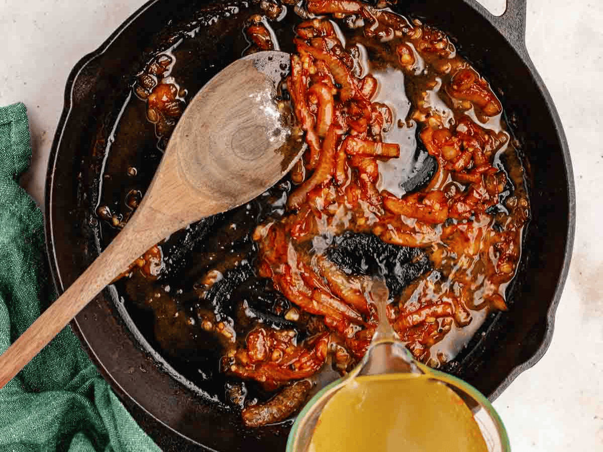 Sautéed onions, garlic, and sun dried tomatoes in pan.