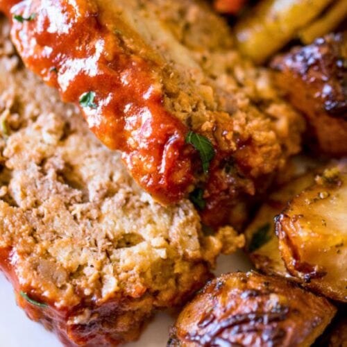 Meatloaf slices on plate with potatoes