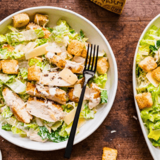 Bowl of salad next to platter of salad
