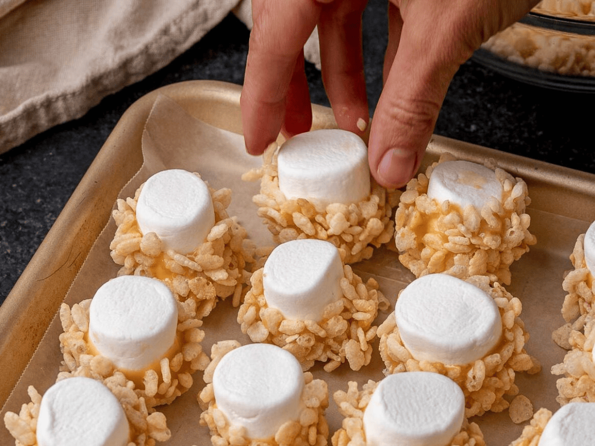 placing dipped marshmallows on a tray