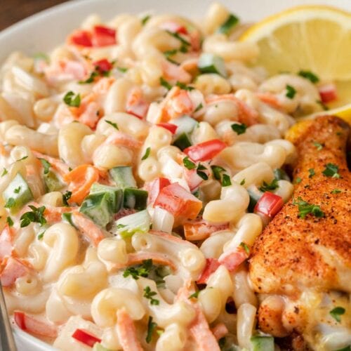 Sweet Macaroni Salad plated salad on plate with lemon slice and baked chicken drumstick. 4x3