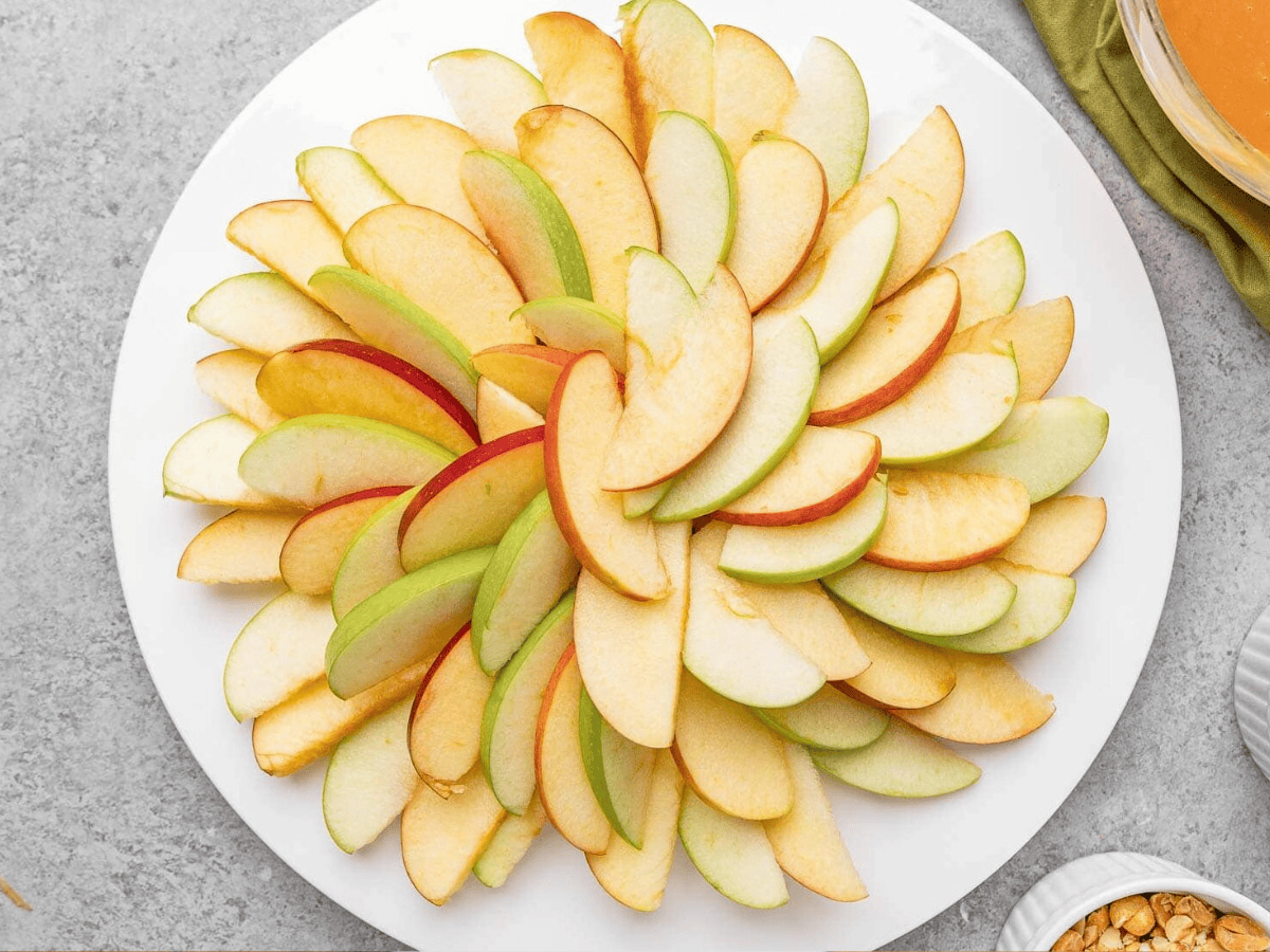 Apple slices fanned out like a flower on plate